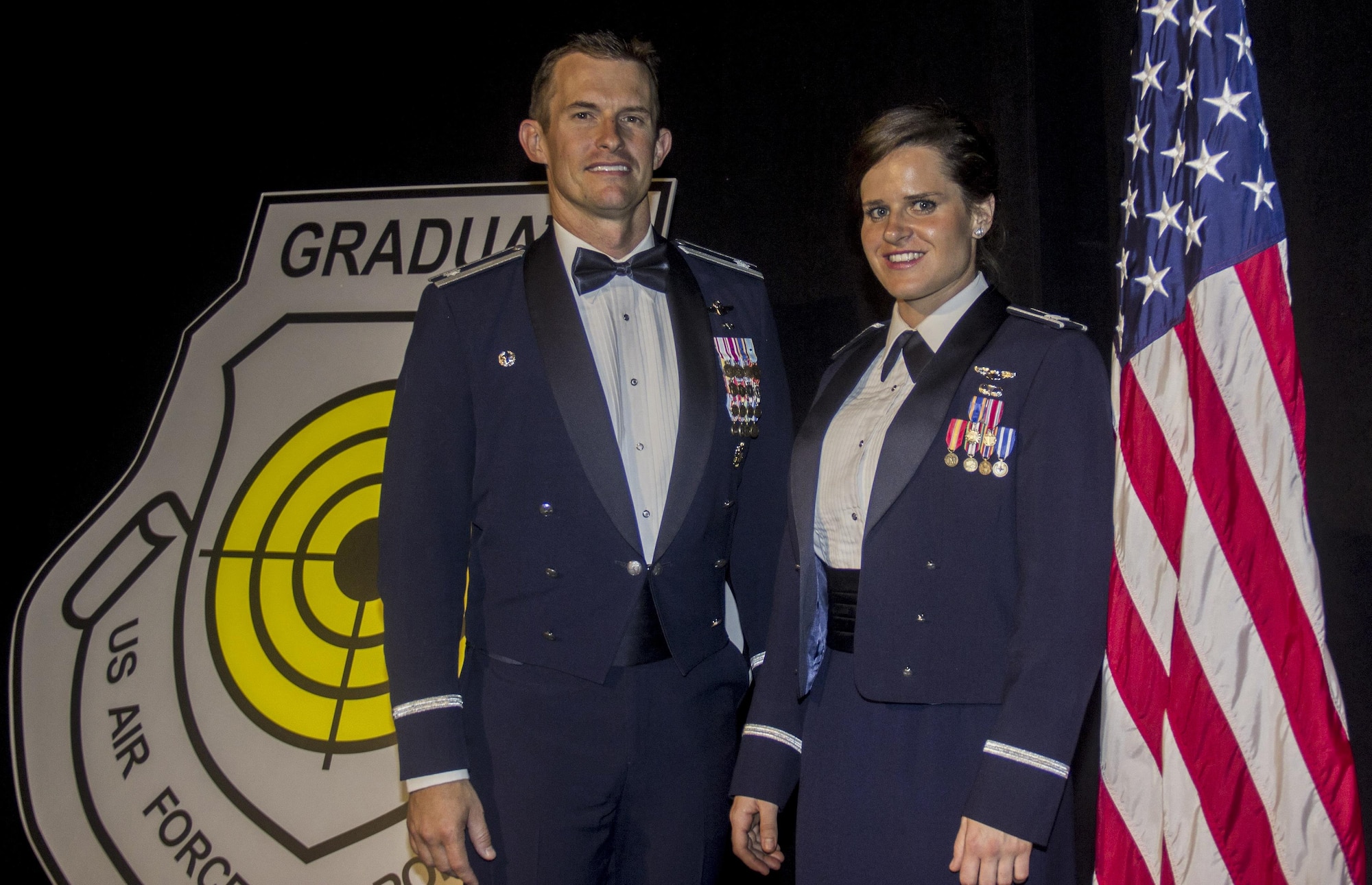 Lt. Col. Scott Mills, U.S. Air Force Weapons School, 66th Weapons Squadron commander and Capt. Jessica Wyble, 66th WPS A-10 Thunderbolt II pilot, pose at the USAFWS graduation ceremony, Las Vegas, June 25, 2016. Wyble is the first woman to successfully complete the USAFWS graduate-level A-10 weapons instructor course that provides the world's most advanced training in weapons and tactics employment (U.S. Air Force photo by Susan Garcia/Released)