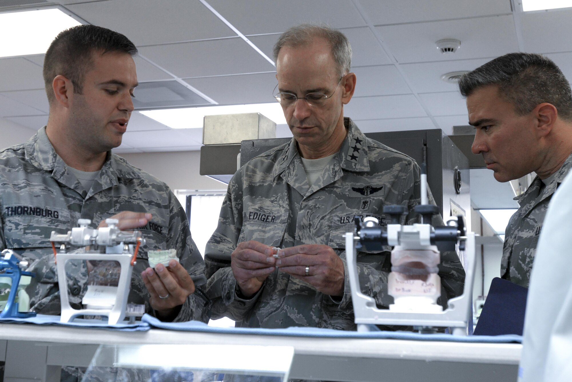 U.S. Air Force Lt. Gen. Mark A. Ediger, middle, Surgeon General of the Air Force, and Chief Master Sgt. Jason E. Pace, right, Chief, Medical Enlisted Force, examine dental equipment at the 48th Dental Squadron dental lab at Royal Air Force Lakenheath, England, July 25. Ediger and Pace visited many of the 48th Medical Group’s facilities during their tour to engage with Airmen and see first-hand the capabilities of Liberty medics. (U.S. Air Force Photo by Airman Eli Chevalier)