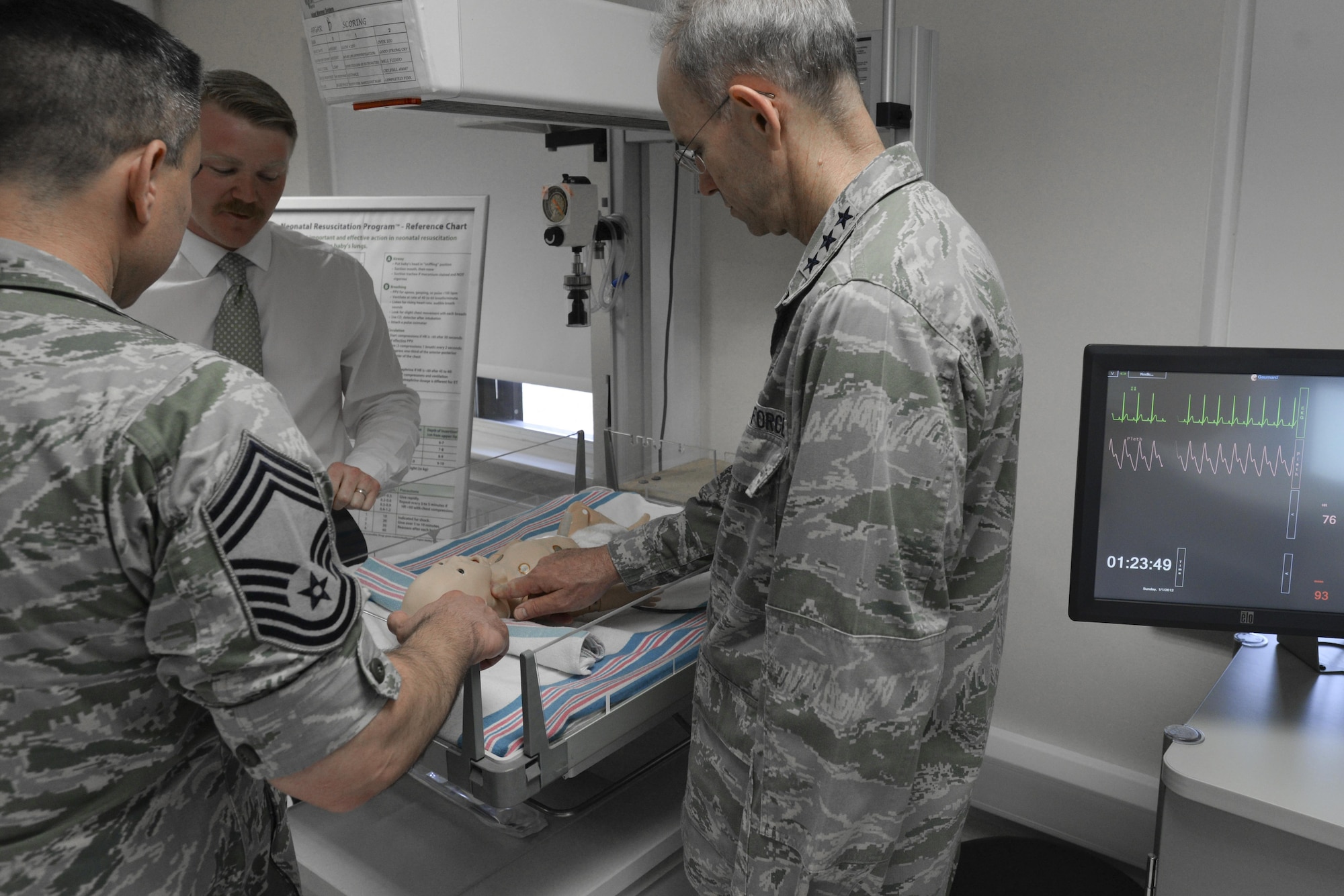 U.S. Air Force Lt. Gen. Mark A. Ediger, right, Surgeon General of the Air Force, and Chief Master Sgt. Jason E. Pace, left, Chief, Medical Enlisted Force, observe a newborn simulator at the 48th Medical Group’s simulation center at Royal Air Force Lakenheath, England, July 25. The newborn simulator allows the 48th MDG to train doctors and nurses on a range of different situations involving newborn children. (U.S. Air Force Photo by Airman Eli Chevalier)