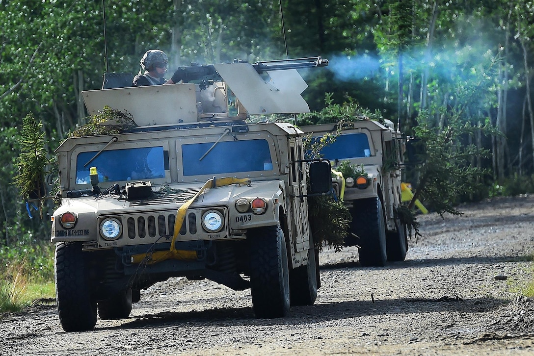 Soldiers role play as opposing forces attack patrolling soldiers, July 25, 2016, during Arctic Anvil 2016, an exercise near Fort Greely, Alaska. Air Force photo by Justin Connaher