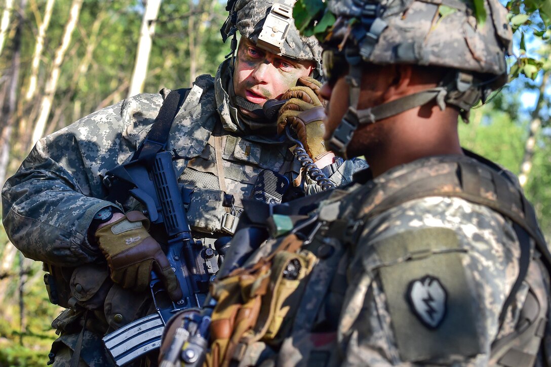 Army 2nd Lt. Tristan Long, left, receives orders during a coordinated opposing forces attack, July 25, 2016, as part of Arctic Anvil 2016, an exercise near Fort Greely, Alaska. Long is assigned to the 25th Infantry Division’s Company A, 1st Battalion, 24th Infantry Regiment, 1st Stryker Brigade Combat Team, Alaska. Air Force photo by Justin Connaher