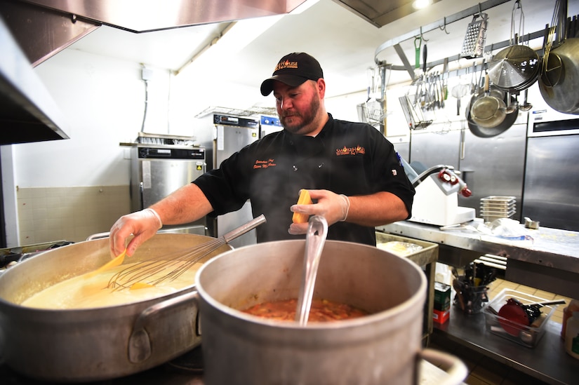 Steve Muhlbaier, Brickhouse 54 executive chef, cooks a fresh batch of cheese sauce in the kitchen of The Courses on Joint Base Andrews, Md., July 27, 2016. Brickhouse 54 is barbeque-themed restaurant at The Courses serving hundreds of customers daily. (U.S. Air Force photo by Senior Airman Joshua R. M. Dewberry)
