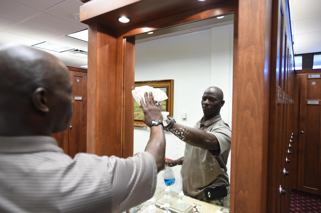 Jimmy Thomas, The Courses facility manager, cleans and maintains the Presidential Lounge at The Courses on Joint Base Andrews, Md., July 27, 2016. Thomas leads a maintenance team that manages a 54-hole golf course, dining area and lounges, catering to approximately 100,000 customers annually. (U.S. Air Force photo by Senior Airman Joshua R. M. Dewberry)