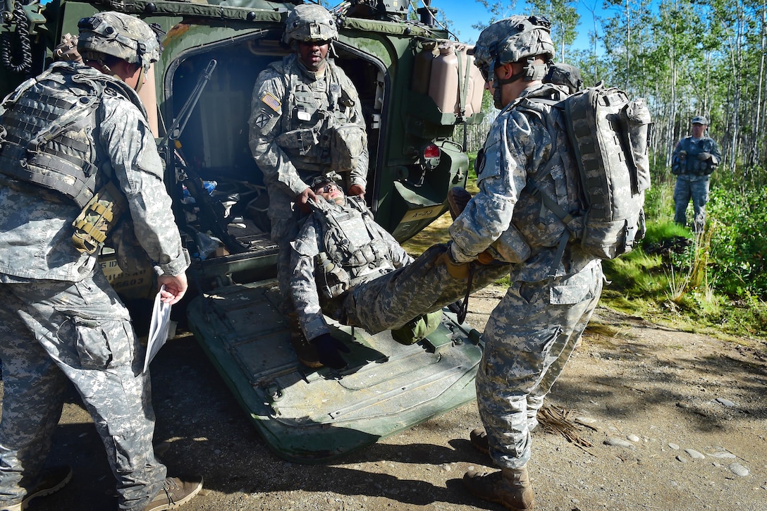 Soldiers unload a role-playing casualty during a coordinated opposing forces attack, July 25, 2016, as part of Arctic Anvil 2016, an exercise near Fort Greely, Alaska. Air Force photo by Justin Connaher