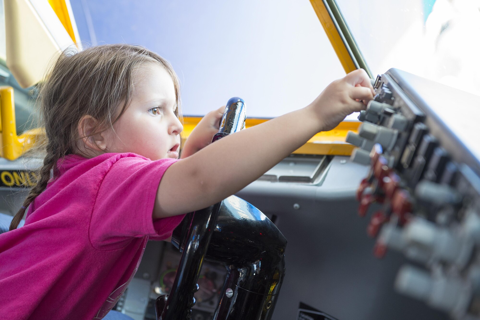 Emily Cook, an airshow attendee, plays with the controls of a KC-135R Stratotanker interactive flight deck during the Dayton Vectron Airshow in Dayton, Ohio, June 18, 2016. Over the course of the two-day event, approximately 5,000 people toured the displays. (U.S. Air Force photo/Tech. Sgt. Benjamin Mota)