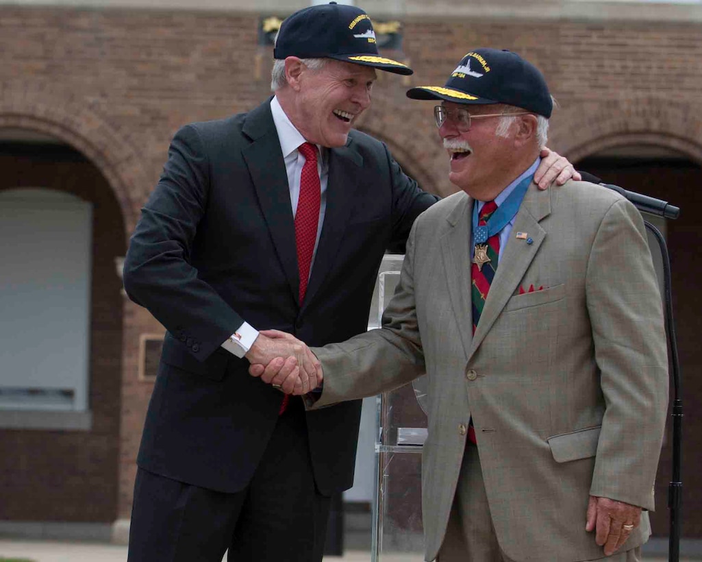 The Honorable Ray Mabus, Secretary of the Navy, shakes hands with Medal of Honor recipient, retired Col. Harvey Barnum during a ship naming ceremony of the U.S. Navy’s newest destroyer in honor of Barnum at Marine Barracks Washington, D.C., July 28, 2016. (Official Marine Corps photo by Cpl. Chi Nguyen)