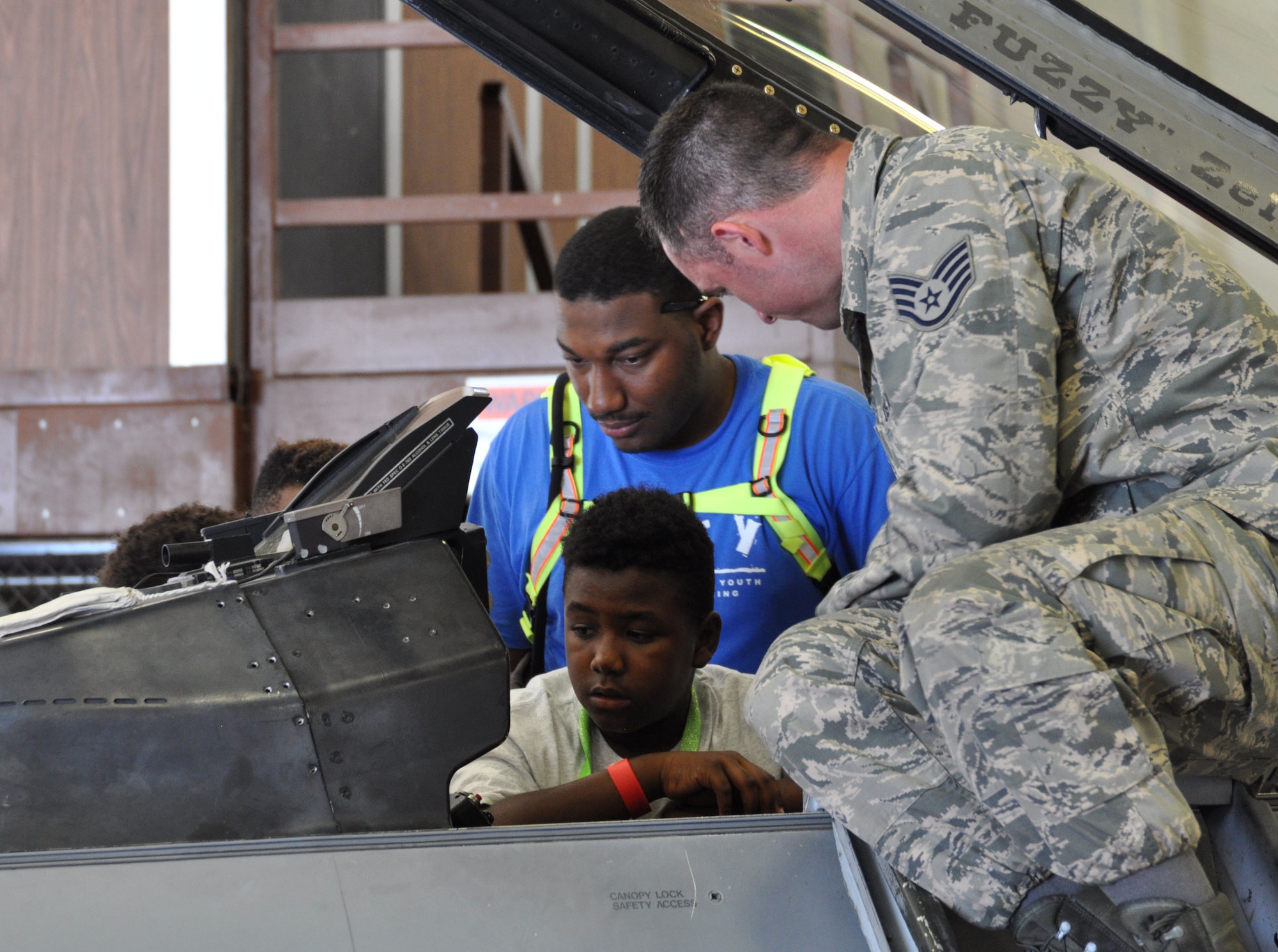 Staff Sgt. Wesley Morey, 495th Fighter Group aircraft maintenance technician, shows children from the Drug Education For Youth (DEFY) a closer look at the 301st Fighter Wing's F-16 during a tour today. The DEFY program is in it's 19th year in coordinating these type of programs with the Naval Air Station Fort Worth Joint Reserve Base, Texas. (U.S. Air Force photo by Julie Briden-Garcia)