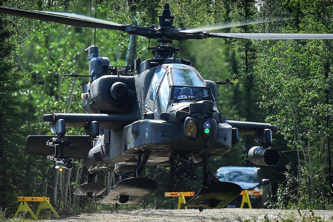 An AH-64 Apache attack helicopter lands on a road near defensive positions during a coordinated opposing forces attack, July 25, 2016, as part of Arctic Anvil 2016, an exercise near Fort Greely, Alaska. Air Force photo by Justin Connaher