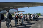 U.S. Air Force Airmen assigned to the South Carolina Air National Guard prepare to board a Boeing 767 transport aircraft at McEntire Joint National Guard Base, S.C., July 13, 2016. Approximately 300 U.S. Airmen and 12 F-16 Fighting Falcon fighter jets from the 169th Fighter Wing at McEntire JNGB, S.C., are deploying to Osan Air Base, Republic of Korea, as the 157th Expeditionary Fighter Squadron in support of the U.S. Pacific Command Theater Security Package. 