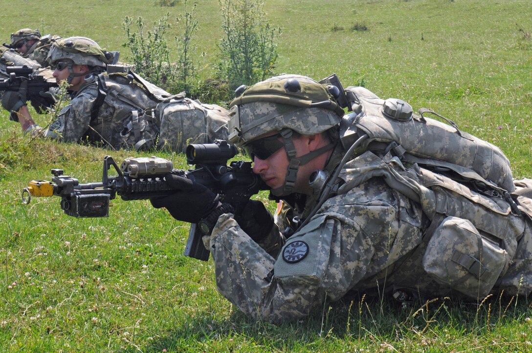 Army National Guard Pvt. 1st Class Wesley Slater takes a defensive position during Saber Guardian 16 at the Romanian Land Force Combat Training Center in Cincu, Romania, July 28, 2016. Army photo by Staff Sgt. Corinna Baltos
