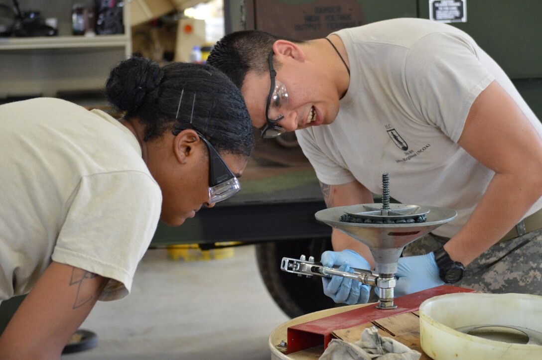 Army Reserve Spc. Martin A. Silva Bel, of 818th Support Maintenance Company, Fort George G. Meade, Md., operates an axle assembly wheel bearing grease pump during Platinum Wrench Annual Exercise at Ft. McCoy, Wis., on July 26, 2016. The hands- on exercise gives Soldiers training in maintenance procedures. (U.S. Army photo by Spc. Thomas Watters/Released)