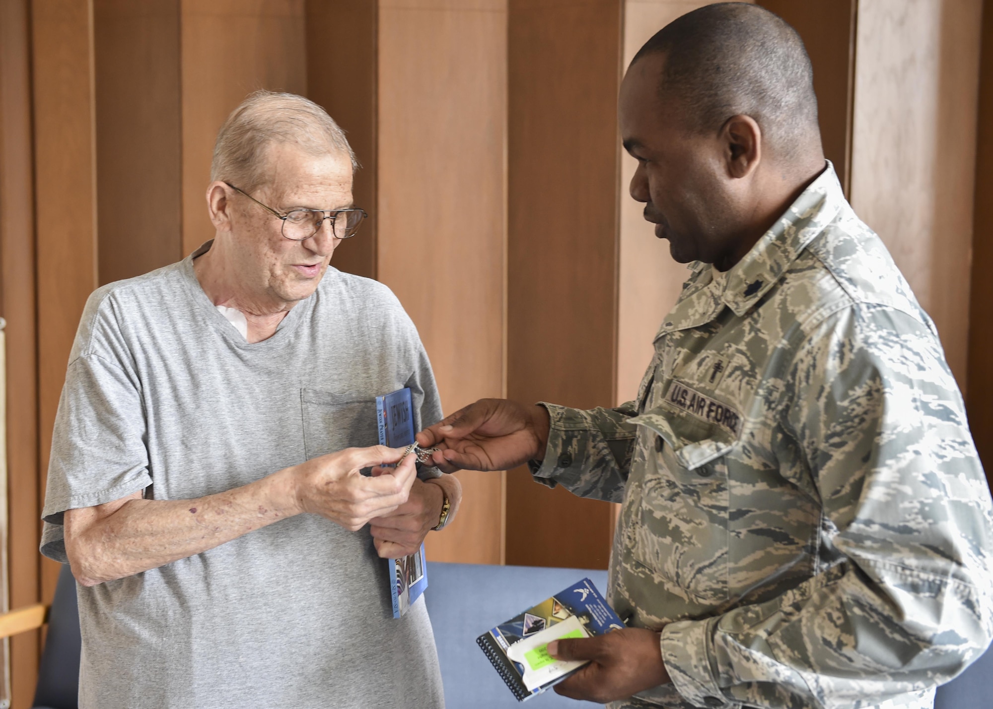 910th Airift Wing Chaplain Lt. Col. Klavens Noel presents Fred Weitz, a former U.S. Air Force member who served from 1955–1959, with a Star of David necklace here, July 28. Noel was contacted by Weitz' assisted living facility for help tracking down a Star of David necklace similar to one he recieved from a chaplain while service with the Air Force. Noel acquired the necklace and visited Weitz at his residence to deliver it and thank him for his service. (U.S. Air Force photo/Eric White)