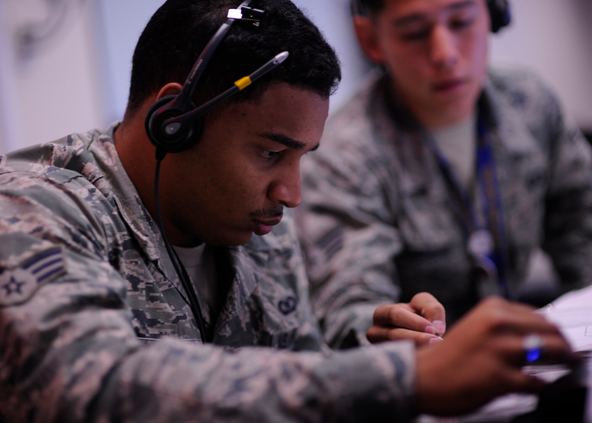 Senior Airman Steven Jovane from the 81st Range Control Squadron takes instruction from an Airman while preparing to conduct a command and control mission at Tyndall Air Force Base, Fla., July 26, 2016. The 81st Range Control Squadron, also known as, “Wet Stone,” provides command and control for air-to-air and air-to-ground live fire missions. (U.S. Air Force photo by Senior Airman Solomon Cook/Released)