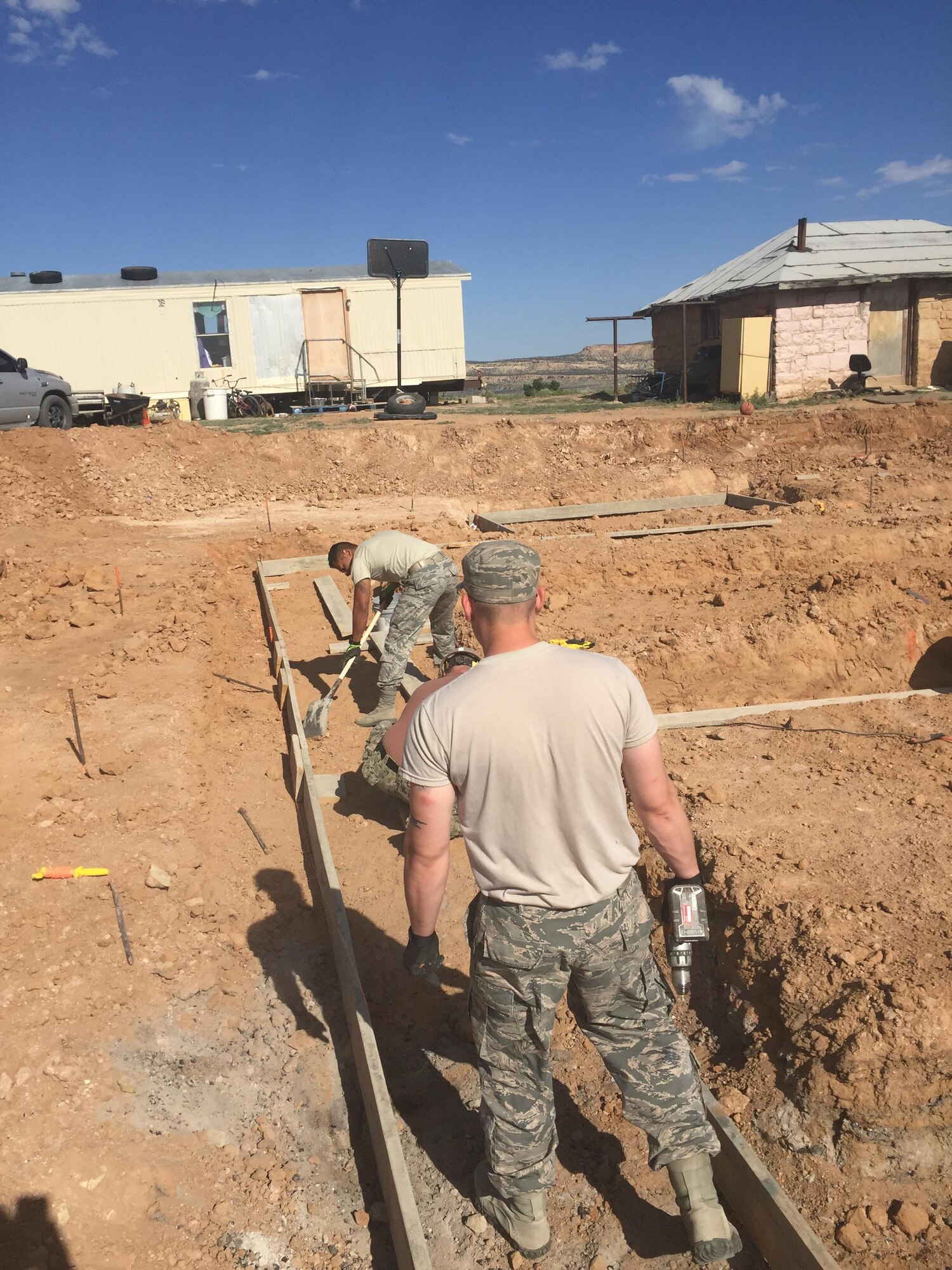 Air Force Reservists from the 302nd Civil Engineer Squadron set up forms to pour concrete for the foundation of a new home May 31, 2016 in Gallup, N.M. As part of the Operation Footprint partnership, twenty-four Reservists from the 302nd CES contributed to completing five new homes for the Navajo Nation while performing Innovative Readiness Training and honing skills for wartime missions. (Courtesy photo)