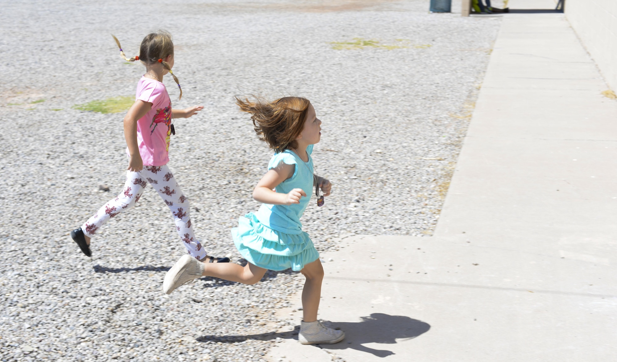 Kendall and Ava, two children attending the base chapel’s vacation bible school, race to their next station after participating in an outdoor activity at Holloman Air Force Base, N.M., on July 20. Stations are set up in various rooms of the base middle school and each station hosts a different activity. (Last names are being withheld due to operational requirements. U.S. Air Force photo by Amn Alexis P. Docherty/released) 