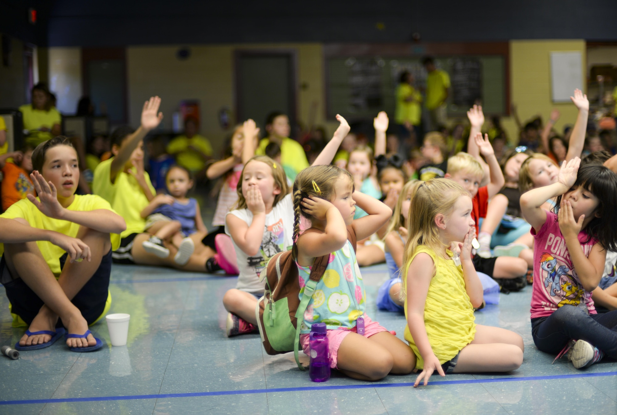 Children attending the base chapel’s vacation bible school assemble in the base middle school’s cafeteria as part of a worship ceremony at Holloman Air Force Base, N.M., on July 20. The children sing and dance along to motivational music videos during the ceremony. (U.S. Air Force photo by Amn Alexis P. Docherty/released)