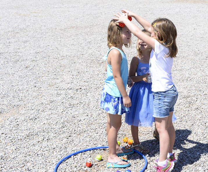 Addalyn, Hailey and Isobel, three children attending the base chapel’s vacation bible school, play together during an outdoor activity at Holloman Air Force Base, N.M., on July 20. Children are grouped by age and participate in activities specifically geared towards their age group. (Last names are being withheld due to operational requirements. U.S. Air Force by Amn Alexis P. Docherty/released) 

