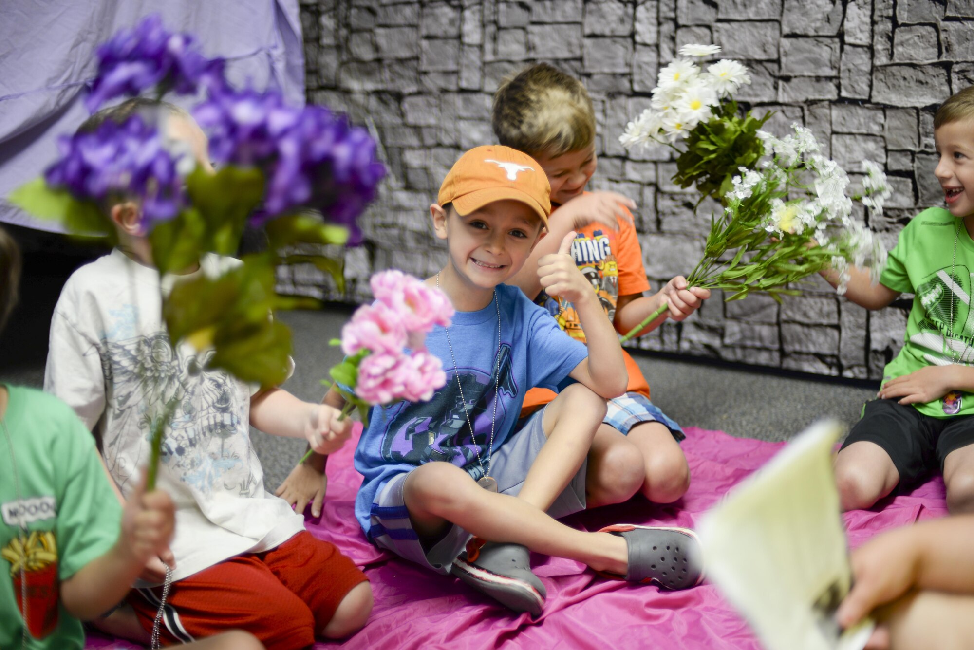 A group of children attending the base chapel’s vacation bible school play with colorful bouquets as part of a volunteer-led discussion at Holloman Air Force Base, N.M., on July 20. This year’s VBS program aims to teach children about God’s love through hands-on activities. (U.S. Air Force photo by Amn. Alexis P. Docherty/released) 