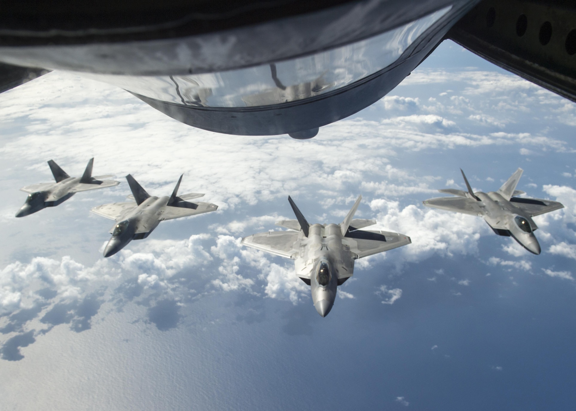 Four U.S. F-22 Raptors from the 199th Fighter Squadron and the 19th Fighter Squadron await refueling from a KC-135R Stratotanker operated by 465th Air Refueling Squadron from Tinker Air Force Base, Oklahoma, during Rim of the Pacific 2016 over Joint Base Pearl Harbor-Hickam, Hawaii, July 26, 2016. (U.S. Navy photo by Mass Communication Specialist 2nd Class Gregory A. Harden II)