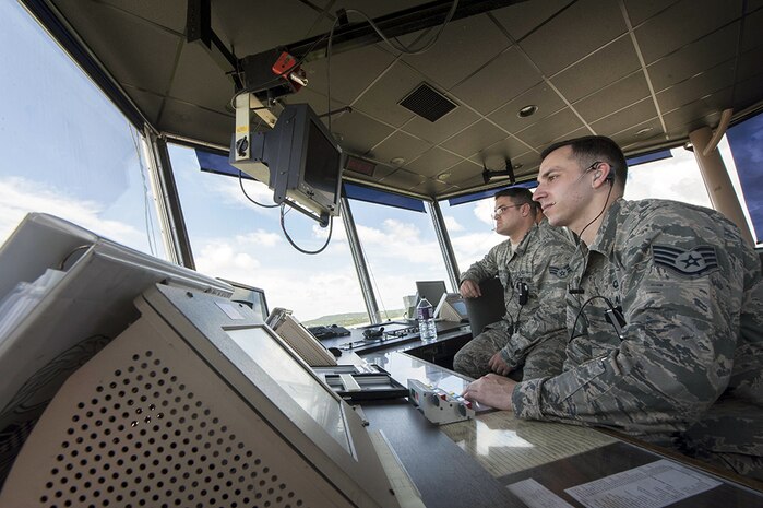 U.S. Air Force Staff Sgt. Louis Kelley and Senior Airman Aaron Funari, 18th Operations Support Squadron air traffic controllers, look out at the flightline July 21, 2016, at Kadena Air Base, Japan. As the Air Force’s largest combat wing, Kadena's airfield is one of the busiest in the Air Force. The operations of the 18th OSS ATC Airmen keep processes running smoothly. 