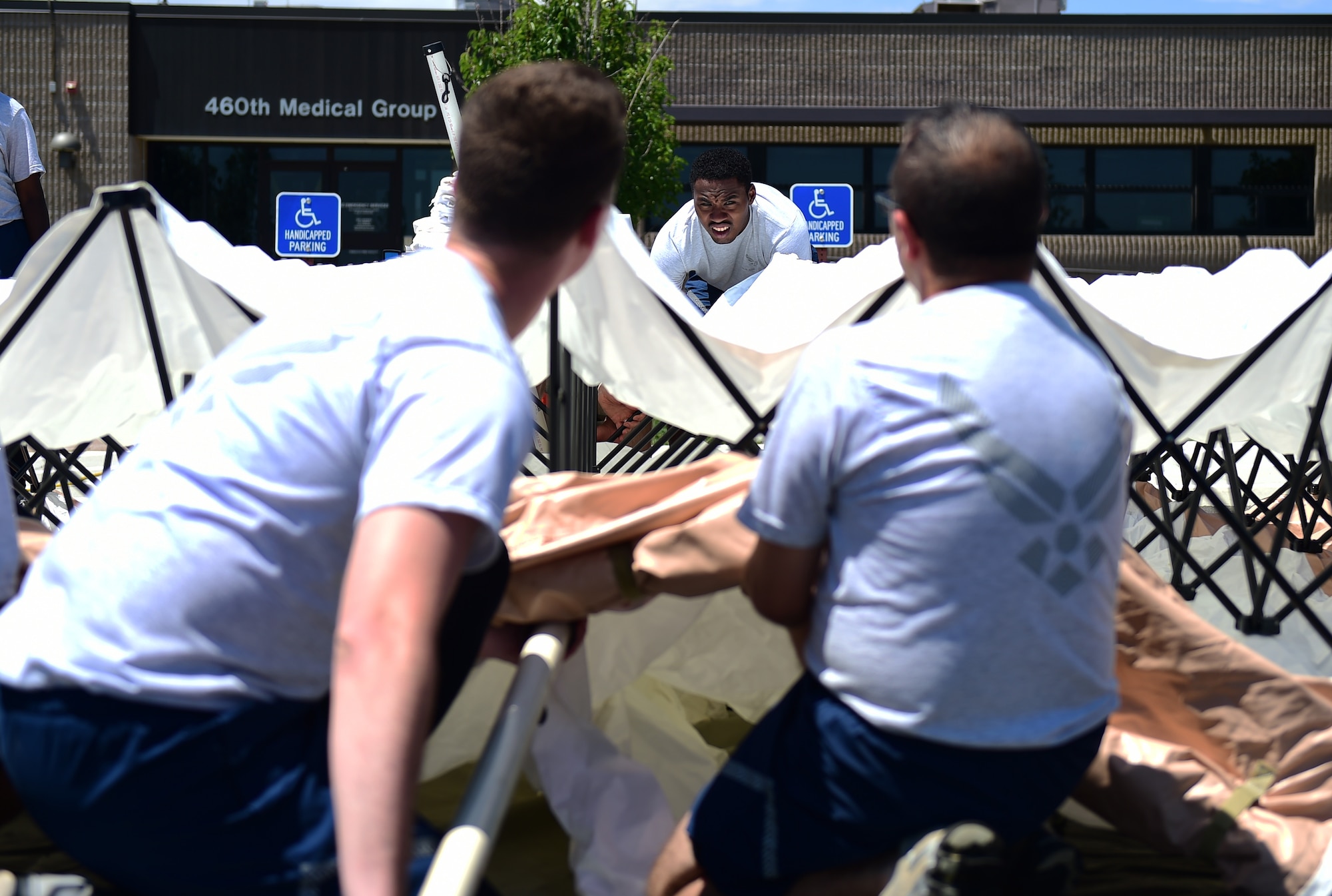 Members of the 460th Medical Group in-place patient decontamination triage and manpower/security team set up a decontamination tent July 21, 2016, during a simulated exercise on Buckley Air Force Base, Colo. The team performed all the necessary tasks under the time constraint to become mission-capable and fully prepared to respond to a series of events. (U.S. Air Force photo by Airman 1st Class Gabrielle Spradling/Released)