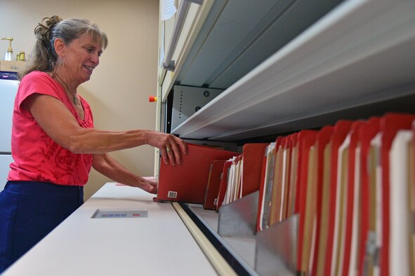 Carolyn Lippert Wood, 341st Contracting Squadron base services flight chief, pulls contract folders from storage July 27, 2016, at Malmstrom Air Force Base, Mont. The contracting squadron is responsible for finding construction, services and commodities for the base while also correctly spending Air Force money. (U.S. Air Force photo/Airman 1st Class Daniel Brosam)