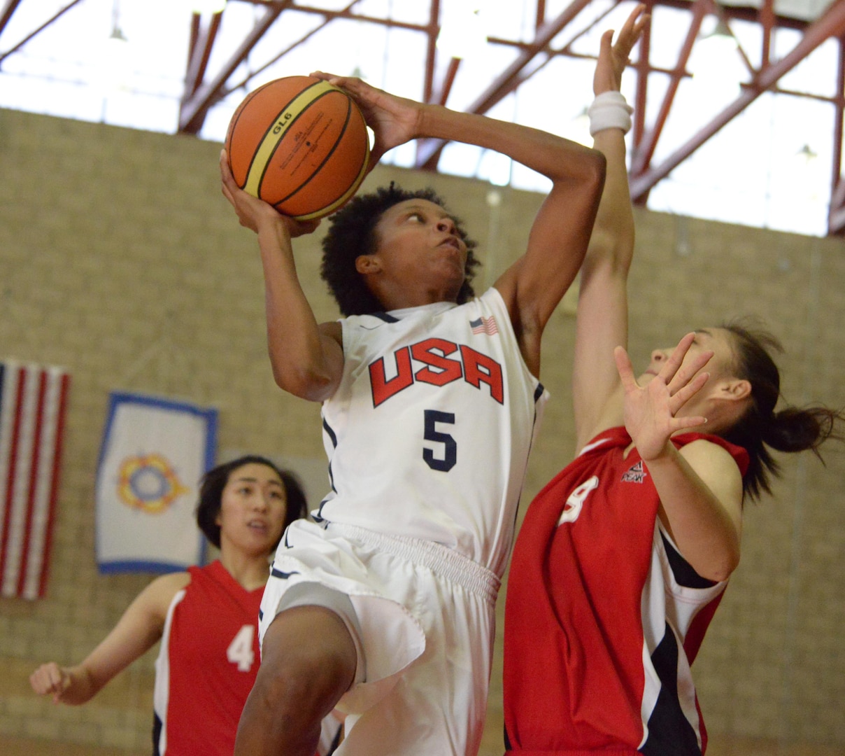 Jessica StCyr of Robbins Air Force Base, Ga., goes in for a layup against China's Jiayi Zuo. USA beat China 73-56 to remain undefeated in day three of the CISM Women's Basketball Championship at Camp Pendleton, Calif., July 27, 2016.