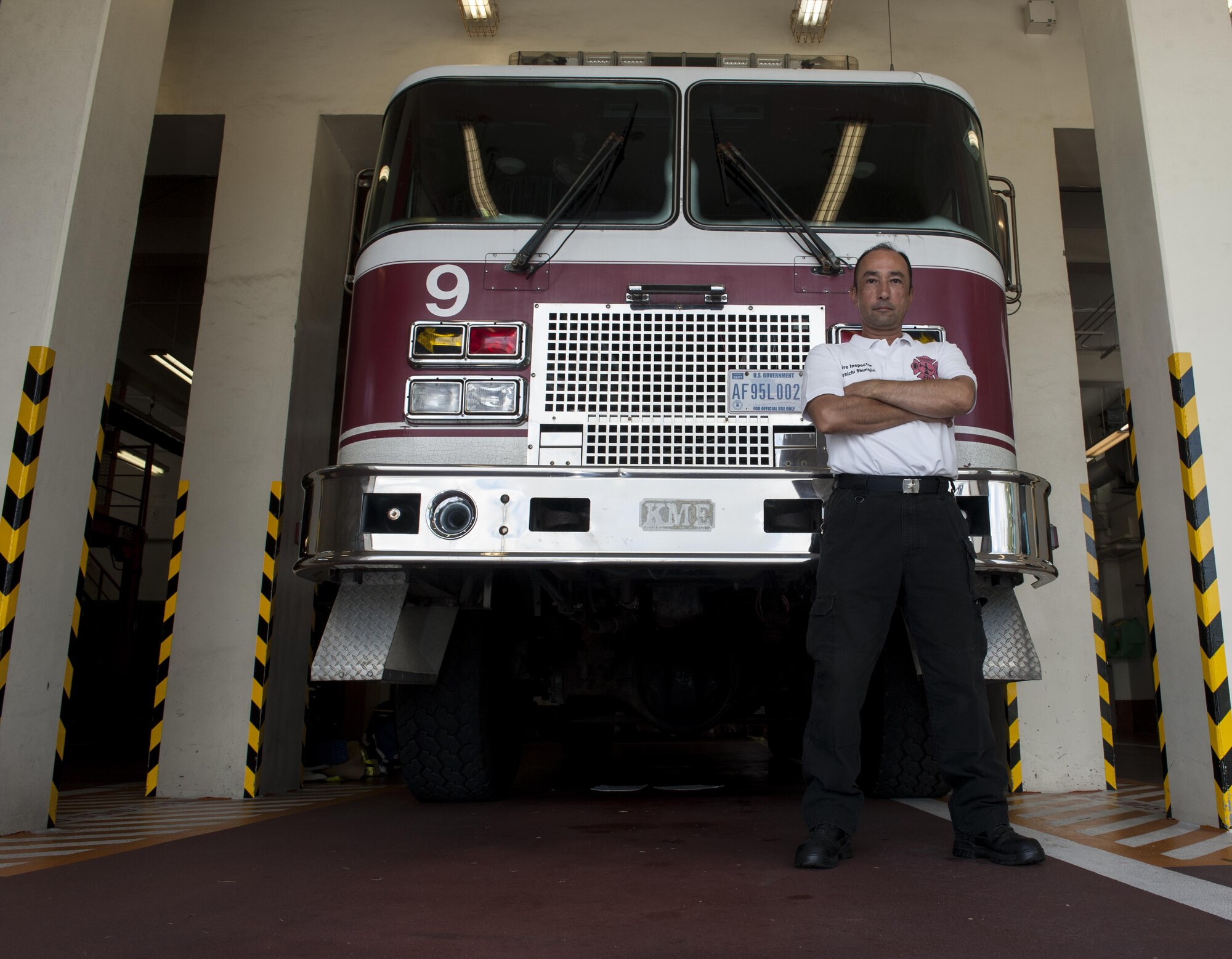 Kenichi Shimajiri, 18th Civil Engineer Squadron fire inspector, stands in front of a fire truck July 27, 2016, at Kadena Air Base, Japan. Shimajiri was a firefighter for 23 years at Kadena before becoming a fire inspector. As a fire inspector, Shimajiri is responsible for ensuring buildings are free of fire hazards. (U.S. Air Force photo by Airman 1st Class Lynette M. Rolen)