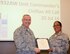 Commander of the 932nd Airlift Wing, Col. Jonathan Philebaum, presents a special certificate recognizing Senior Master Sgt. Teresa Ray with 30 years of outstanding service to the United States government. She was congratulated during the 932nd Airlift Wing Commander's Civilian All Call on July 20, 2016.  (U.S. Air Force photo by Maj. Stan Paregien)