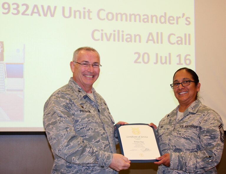 Commander of the 932nd Airlift Wing, Col. Jonathan Philebaum, presents a special certificate recognizing Senior Master Sgt. Teresa Ray with 30 years of outstanding service to the United States government. She was congratulated during the 932nd Airlift Wing Commander's Civilian All Call on July 20, 2016.  (U.S. Air Force photo by Maj. Stan Paregien)