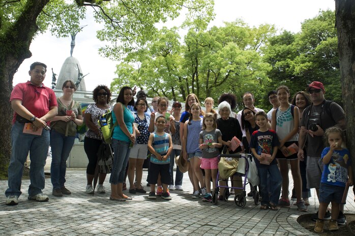 Kikuko Shinjo, better known as ‘Shinjo-Sensei,’ an 89 year-old native of Iwakuni and survivor of the atomic bombing in Hiroshima during World War II, poses with a group of Marine Corps Air Station Iwakuni residents while visiting the Children’s Peace Monument at Hiroshima Peace Memorial Park, Japan, July 15, 2016. Shinjo invited a group of MCAS Iwakuni residents to help her donate 1,000 paper cranes, which she folded, to the Children’s Peace Monnument at Hiroshima Peace Memorial Park as a symbol for peace. (U.S. Marine Corps photo by Lance Cpl. Donato Maffin)