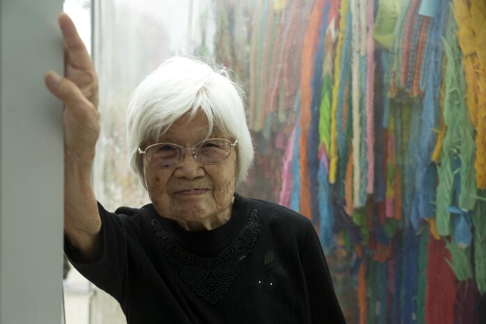 Kikuko Shinjo, better known as ‘Shinjo-Sensei,’ an 89 year-old native of Iwakuni and survivor of the atomic bombing in Hiroshima during World War II, poses in front of paper cranes donated to the Children’s Peace Monument at the Hiroshima Peace Memorial Park, Japan, July 15, 2016. Shinjo invited a group of Marine Corps Air Station Iwakuni residents to help her donate 1,000 paper cranes, which she folded, to the Children’s Peace Monument at Hiroshima Peace Memorial Park as a symbol for peace. (U.S. Marine Corps photo by Lance Cpl. Donato Maffin) 