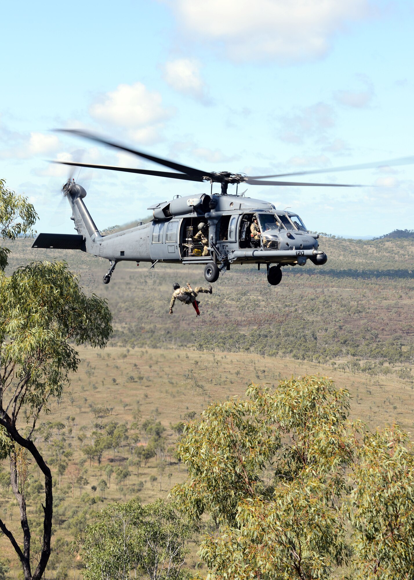 A pararescueman with the 129th Rescue Wing rappels from an HH-60G Pave Hawk helicopter in the High Range of the Australian military zone during operation Angel Reign exercise, July 4, 2016.   (U.S. Air National Guard photo by Senior Airman Zachiah Roberson/released)