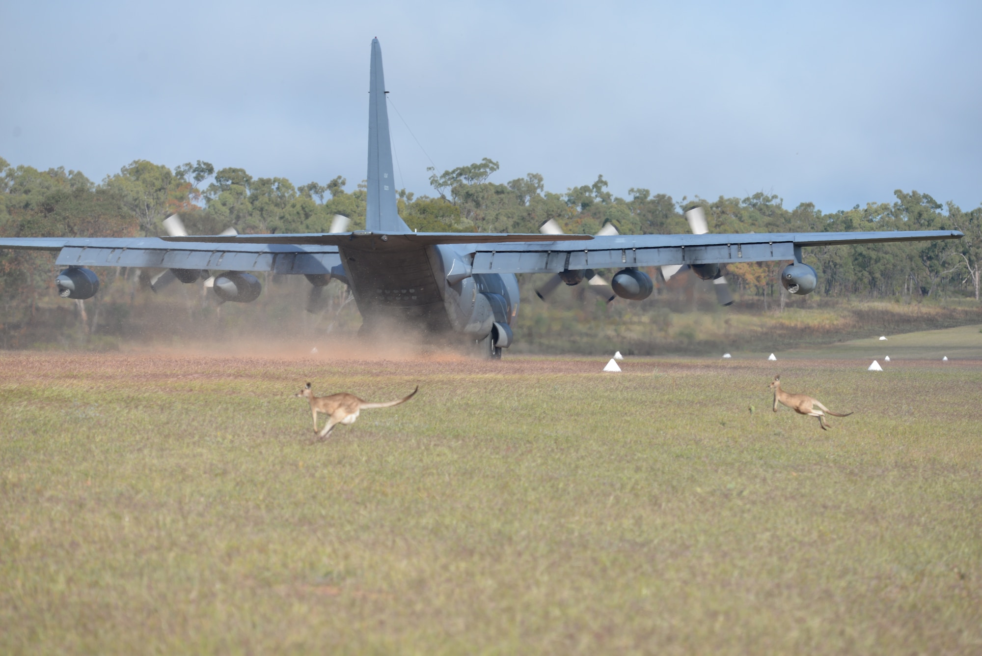 An MC-130P Combat Shadow aircraft lands in a grass landing-zone during an exercise for operation Angel Reign at the High Range near Townsville Australia, July 5, 2016.  (U.S. Air National Guard photo by Senior Airman Zachiah Roberson/released)