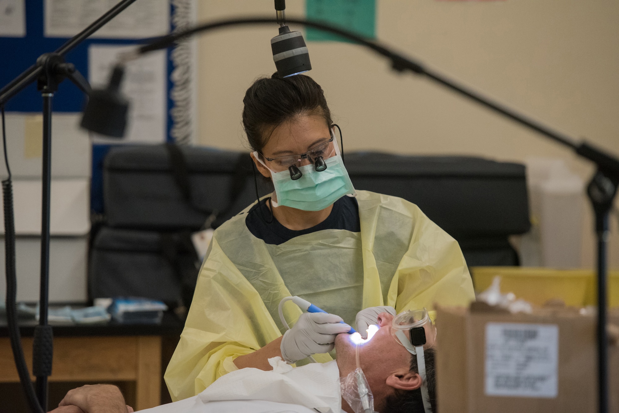 U.S. Navy Petty Officer 2nd Class Tina Girot, a dental hygienist with Expeditionary Medical Facility Great Lakes, Detachment L, provides dental care for a Western Kentucky resident at Paducah Tilghman High School in Paducah, Ky., July 18, 2016, during Bluegrass Medical Innovative Readiness Training. The Kentucky Air National Guard, U.S. Navy Reserve and other military units are teaming with the Delta Regional Authority to offer medical and dental care at no cost to residents in three Western Kentucky locations from July 18 to 27. (U.S. Air National Guard photo by Master Sgt. Phil Speck)