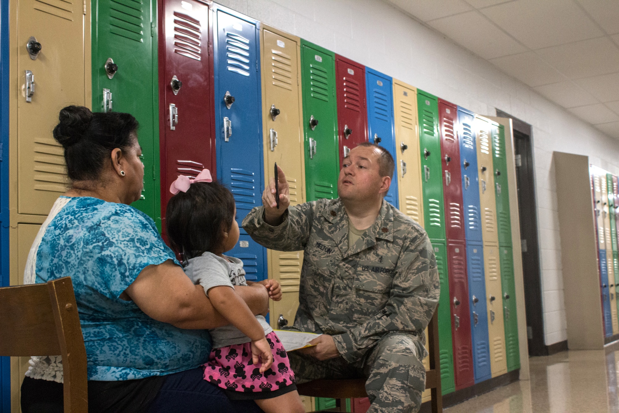 Maj. Derek Melton, an optometrist with the Indiana Air National Guard's 181st Intelligence Wing Medical Group, performs a vision exam on a patient at Graves County High School in Mayfield, Ky., July 21, 2016. The Kentucky Air National Guard, several other Air National Guard units, the U.S. Navy Reserve and the Army National Guard are providing medical and dental care at no cost to residents in three Western Kentucky locations from July 18 to 27. The program is co-sponsored by the U.S. Department of Defense and the Delta Regional Authority. (U.S. Navy Reserve photo by Petty Officer 2nd Class Cathan Bricker)