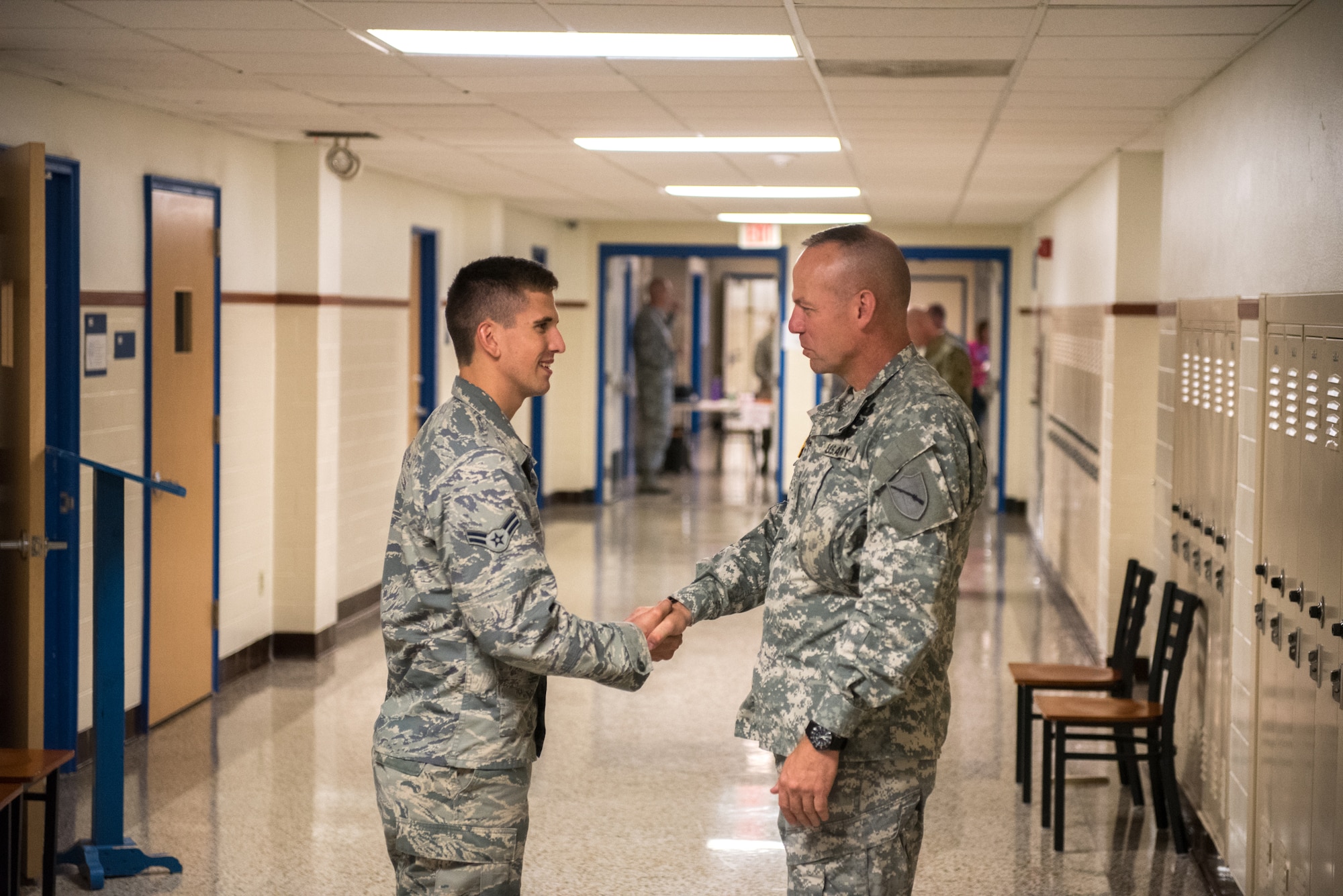 U.S. Army Brig. Gen. Stephen R. Hogan (right), adjutant general of the Kentucky National Guard, presents a coin for excellence to U.S. Air Force Airman 1st Class Trevor Luth, a medic from the Kentucky Air National Guard’s 123rd Medical Group, at Paducah Tilghman High School in Paducah, Ky., July 22, 2016. Luth is one of more than 200 Air and Army National Guardsmen and U.S. Navy Reservists who are operating three medical and dental clinics in Western Kentucky to provide no-cost care to residents from July 18 through 27. (U.S. Air National Guard photo by Master Sgt. Phil Speck)