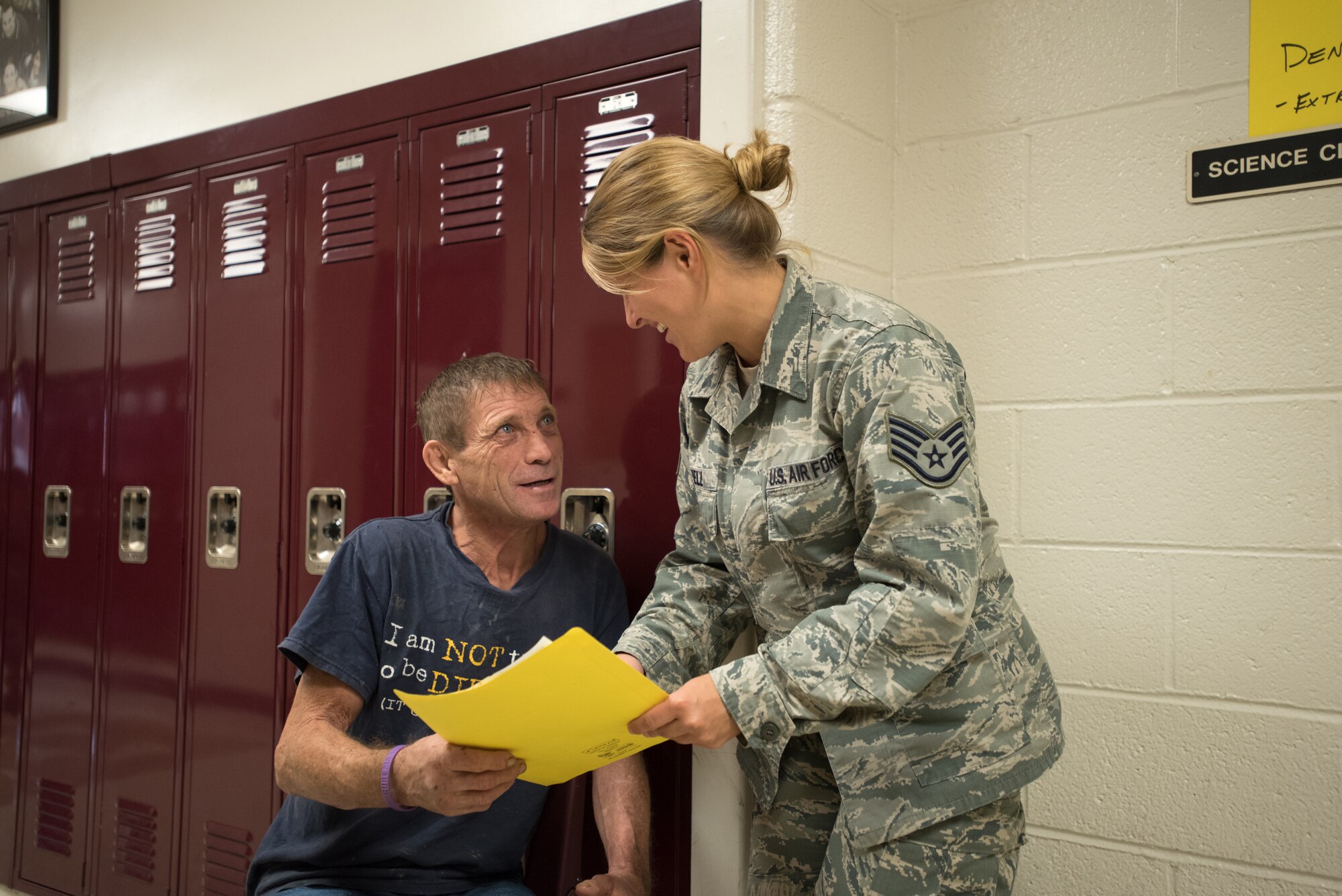 U.S. Air Force Staff Sgt. Katy Jewell (right), a medical technician from the Kentucky Air National Guard’s 123rd Medical Group Detachment 1, processes paperwork for a dental examination from Western Kentucky resident Troy Burgess at Carlisle County High School in Bardwell, Ky., July 23, 2016, during Bluegrass Medical Innovative Readiness Training. The Kentucky Air National Guard, U.S. Navy Reserve and other military units are teaming with the Delta Regional Authority to offer medical and dental care at no cost to residents in Mayfield and two other Western Kentucky locations from July 18 to 27 as part of the training event. (U.S. Air National Guard photo by Master Sgt. Phil Speck)
