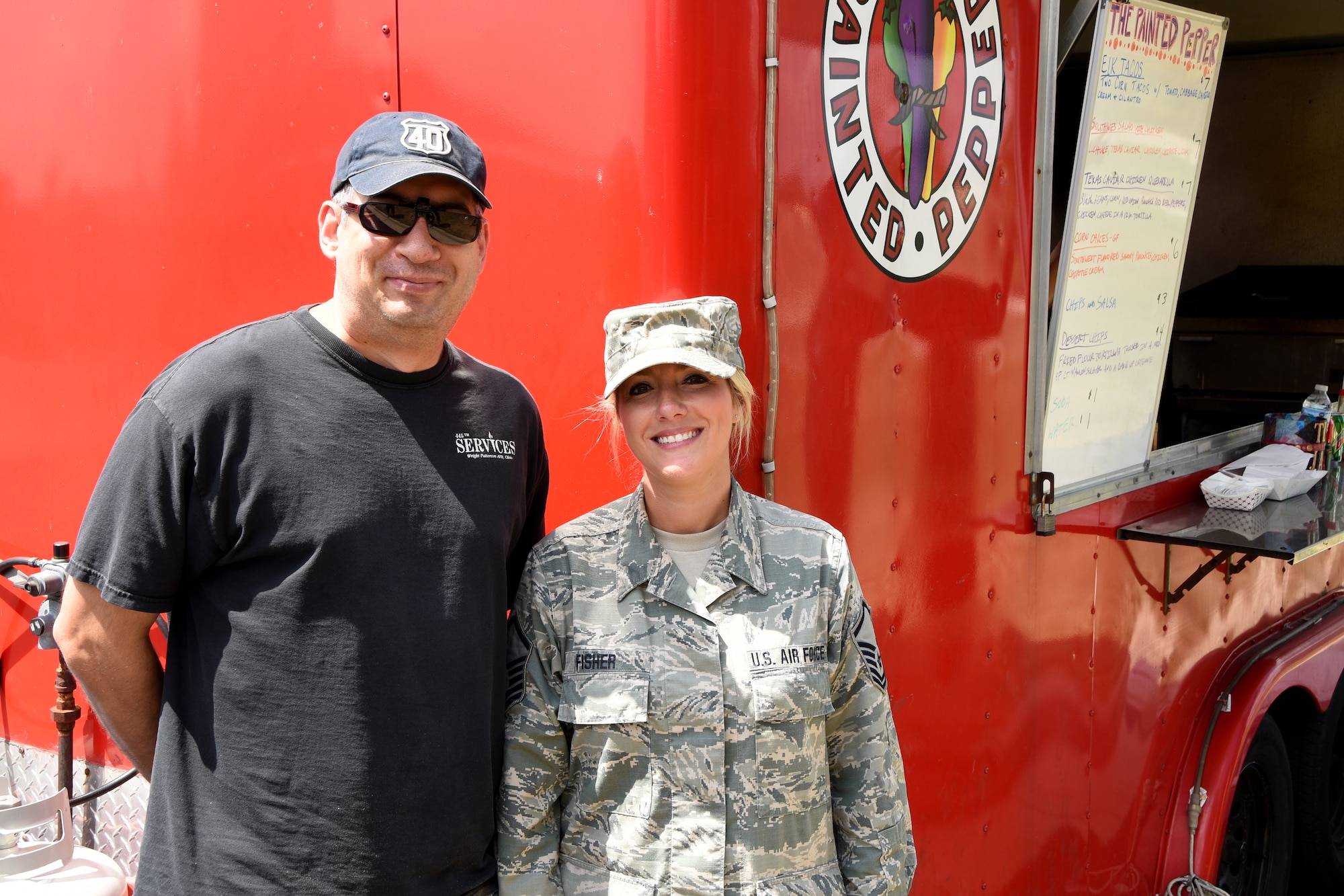 Tech. Sgt. Jason Hague, 178th Services Flight and Master Sgt. Andrea Fisher, wing staff stand in front of the Painted Pepper food truck July 27 at the Springfield Ohio Air National Guard base. 
Their cooperative effort will bring a variety of food trucks to the base once a week throughout the rest of the summer.