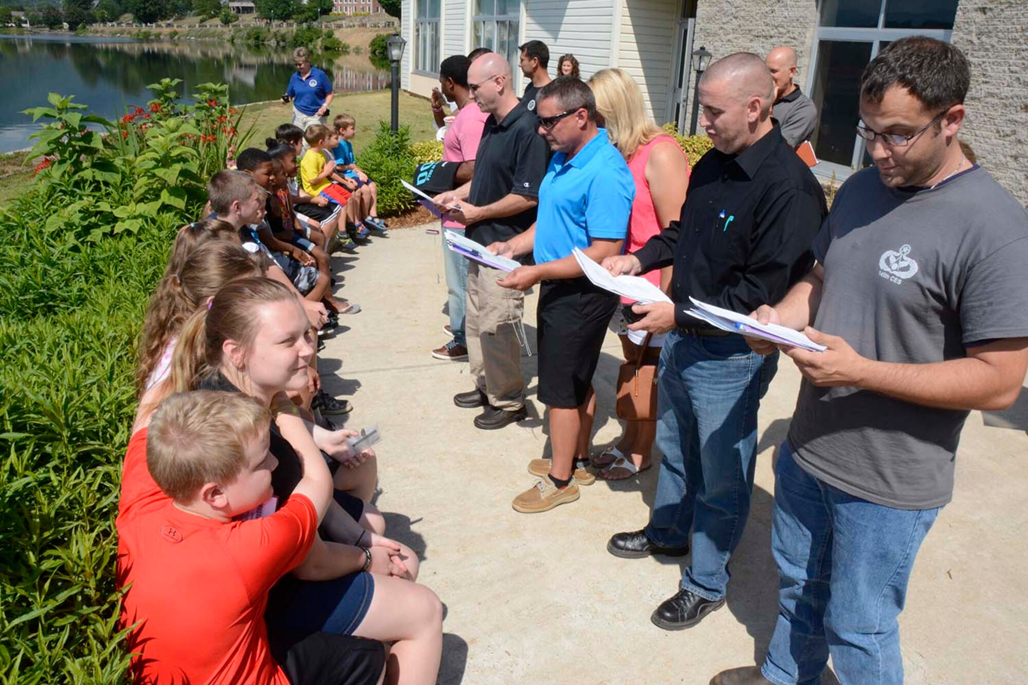 Members of the 145th Airlift Wing recite a poem during a ceremony held in their honor to recognize their children for being helpful and very brave while they were deployed, at a Yellow Ribbon event held June 26, 2016 at Lake Junaluska, N.C. The North Carolina Air National Guard’s Yellow Ribbon Program serves as a series of stepping stones to help reunite families and reacclimatize Airmen and Soldiers back to the civilian world after deployments. (U.S. Air National Guard photo by Master Sgt. Patricia F. Moran/Released)