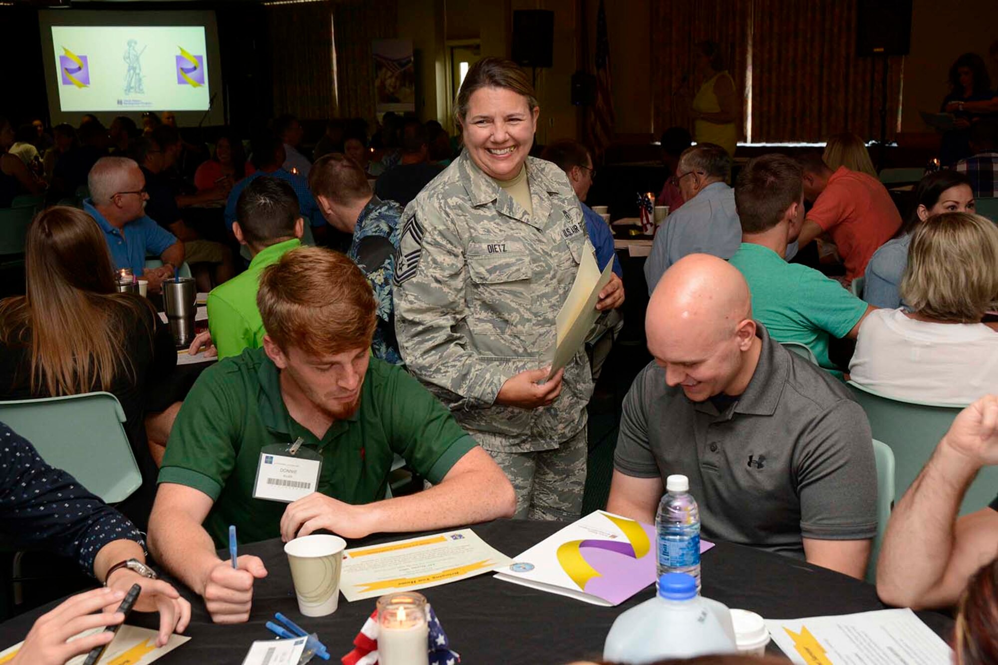 U.S. Air Force Chief Master Sgt. Susan Dietz, 145th Medical Group, passes out certificates during a Yellow Ribbon event, held at Lake Junaluska, N.C., June 26, 2016. There were 179 participants including 77 service members. The North Carolina Air National Guard’s Yellow Ribbon Program serves as a series of stepping stones to help reunite families and reacclimatize Airmen and Soldiers back to the civilian world after deployments. Events are held 30 days prior to a deploying unit and then at 30, 60, and 90 day intervals following the member’s return. (U.S. Air National Guard photo by Master Sgt. Patricia F. Moran/Released)