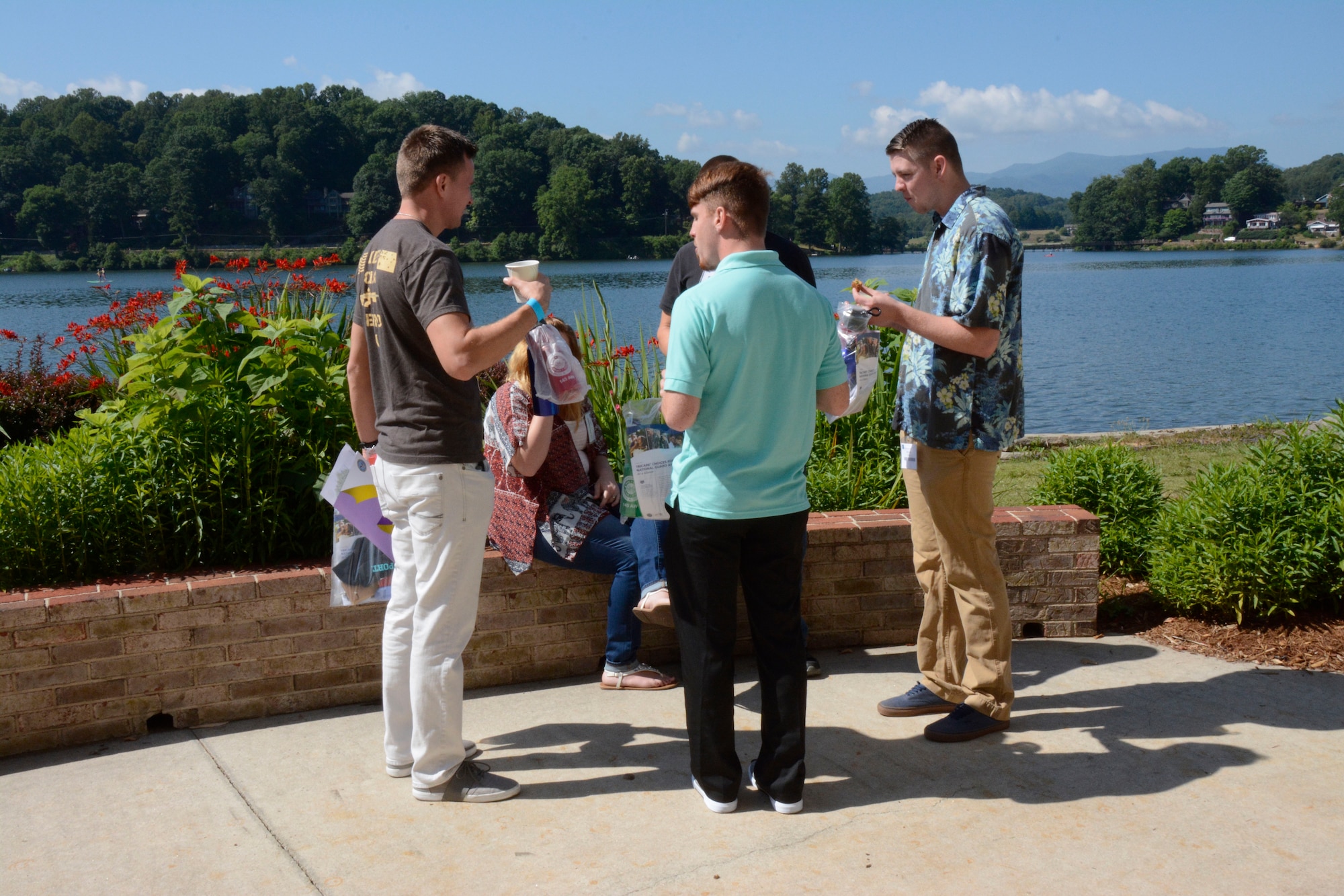 U.S. Air Force Airmen from the North Carolina Air National Guard, take a break to enjoy refreshments and the view during a Yellow Ribbon event held at Lake Junaluska, N.C., June 25 and 26, 2016. More than 170 Airmen and their families participated in this post deployment event. The North Carolina Air National Guard’s Yellow Ribbon Program serves as a series of stepping stones to help reunite families and reacclimatize Airmen and Soldiers back to the civilian world after deployments. Events are held 30 days prior to a deploying unit and then at 30, 60, and 90 day intervals following the member’s return. (U.S. Air National Guard photo by Master Sgt. Patricia F. Moran/Released)