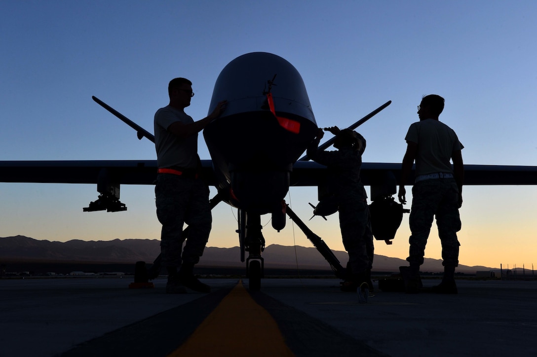 Airmen from the 432nd Aircraft Maintenance Squadron perform maintenance on an MQ-9 Reaper in preparation to support Red Flag 16-3 at Creech Air Force Base, Nev., July 20, 2016. The exercise also incorporated aircraft platforms from U.S. military services and coalition partners in a variety of training scenarios. (U.S. Air Force photo/Airman 1st Class Kristan Campbell)             