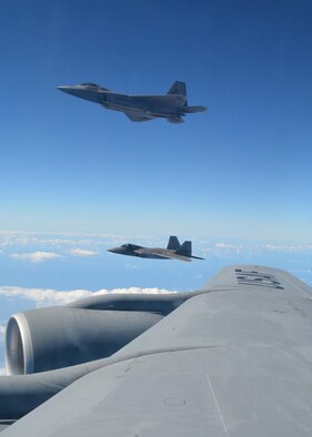 Two F-22 Raptors assigned to Joint Base Pearl Harbor-Hickam, Hawaii, fly alongside the wing of a KC-135R Stratotanker flown by Citizen Airmen with the 465th Air Refueling Squadron (ARS), Tinker Air Force Base, Okla.   Since arriving in Hawaii July 7, the 465th ARS along with other Reserve units have offloaded over 2 million pounds of fuel to U.S. and Royal Canadian aircraft during RIMPAC 2016. (U.S. Air Force video by Tech. Sgt. Lauren Gleason)