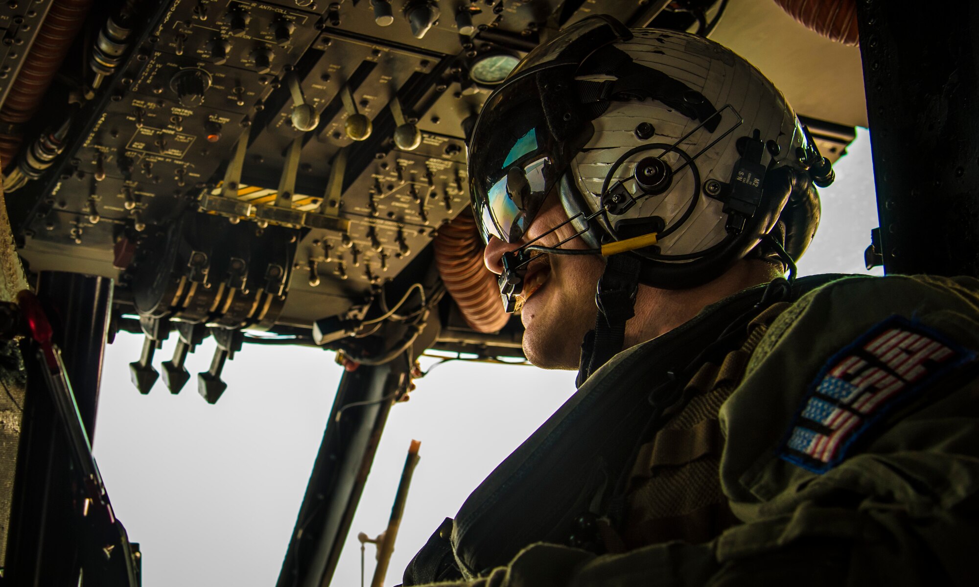 U.S. Navy Petty Officer 2nd Class Morgan Boltz, a naval aircrewman with the Helicopter Mine Countermeasures Squadron 14, Detachment 2A, looks out of the window of an MH-53E Sea Dragon while taking part in Mine Countermeasures Exercise 2JA near Misawa Air Base, Japan, July 22, 2016. The annual bilateral exercise took place between the U.S. and Japan from July 15 to 30, with the goal of strengthening interoperability and mine countermeasure capabilities. (U.S. Air Force photo by Senior Airman Jordyn Fetter)