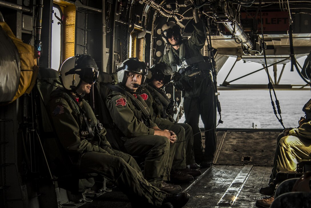 U.S. Navy Sailors with the Helicopter Mine Countermeasures Squadron 14, Detachment 2A, ride in the back of an MH-53E Sea Dragon while taking part in the Mine Countermeasures Exercise 2JA near Misawa Air Base, Japan, July 22, 2016. Though originally stationed in Norfolk, Virginia, the detachment is currently forward deployed to Pohang, Republic of Korea. The unit participated in the 15-day Japan Maritime Self-Defense Force exercise to bolster mine countermeasures capabilities and enhance interoperability between the two allied nations. (U.S. Air Force photo by Senior Airman Jordyn Fetter)
