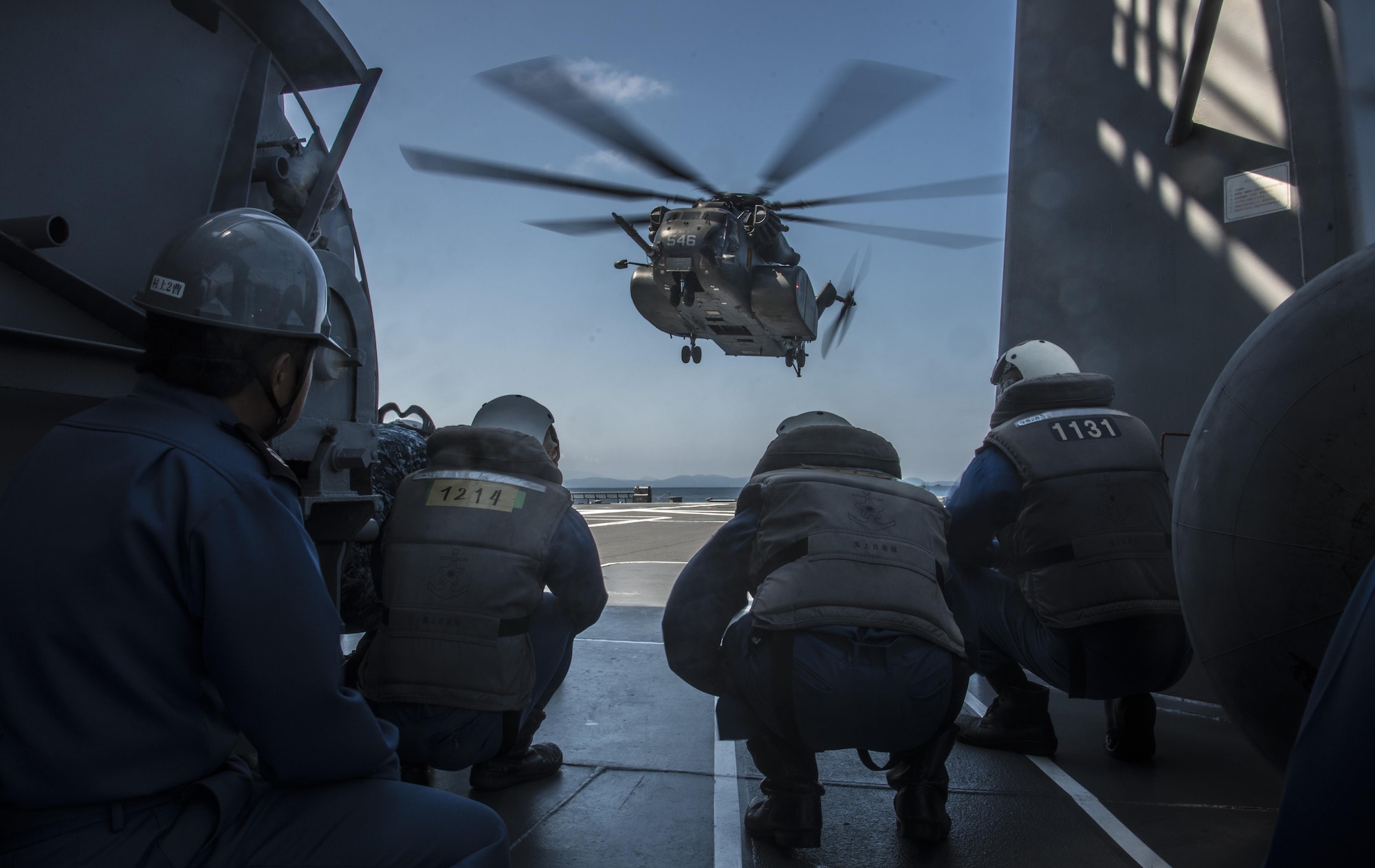 Members of the Japan Maritime Self-Defense Force prepare to receive an MH-53E Sea Dragon aboard the JS Uraga, while taking part in Mine Countermeasures Exercise 2JA in Mutsu Bay, Japan, July 22, 2016. The 99-foot-long helicopter has two missions: airborne mine counter measure and navy vertical onboard delivery. During the exercise, the U.S. Navy operated out of Misawa Air Base, Japan, to practice these missions while improving interoperability with the JMSDF. (U.S. Air Force photo by Senior Airman Jordyn Fetter)