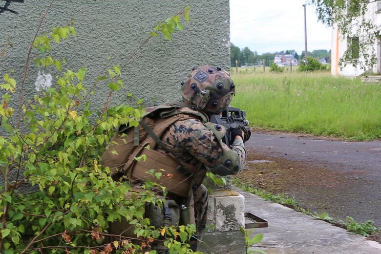 U.S. Marine Corps Lance Cpl. Levi, M. Foss, a rifleman with Charlie Company, 1st Battalion 8th Marine Regiment, Special Purpose Marine Air-Ground Task Force-Crisis Response-Africa posts security on a building corner during a combined arms attack aboard Camp Sissonne, France, June 21, 2016. CENZUB provided SPMAGTF-CR-AF Marines with the ability to maintain their proficiencies in urban combat and integrate with French personnel and assets in a realistic scenario. (U.S. Marine Corps photo by Sgt. Kassie McDole/Released.)