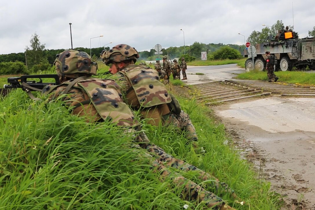 U.S. Marines with Charlie company, 1st Battalion 8th Marine Regiment, Special Purpose Marine Air-Ground Task Force-Crisis Response-Africa provdie security for French Army soldiers with the 34th Infantry Regiment during a combined arms attack aboard Camp Sissonne, France, June 21, 2016. During CENZUB training, SPMAGTF-CR-AF Marines had the opportunity to work in cooperation with company of French Army soldiers, integrating their skills and resources including weaponry and military vehicles to form an effective battle plan, similar to what they may face in the event of a future crisis. (U.S. Marine Corps photo by Sgt. Kassie McDole/Released.) 