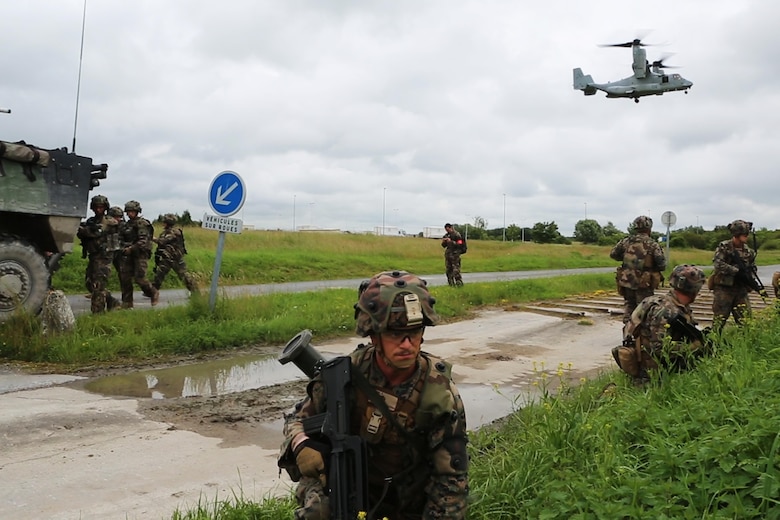 U.S. Marines with Charlie company, 1st Battalion 8th Marine Regiment, Special Purpose Marine Air-Ground Task Force-Crisis Response-Africa provdie security for French Army soldiers with the 34th Infantry Regiment during a combined arms attack aboard Camp Sissonne, France, June 21, 2016. During CENZUB training, SPMAGTF-CR-AF Marines had the opportunity to work in cooperation with company of French Army soldiers, integrating their skills and resources including weaponry and military vehicles to form an effective battle plan, similar to what they may face in the event of a future crisis. (U.S. Marine Corps photo by Sgt. Kassie McDole/Released.)